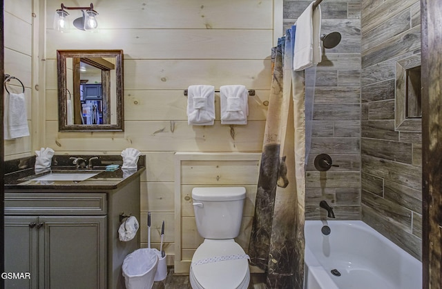 full bathroom featuring vanity, wood walls, shower / bathtub combination with curtain, and toilet