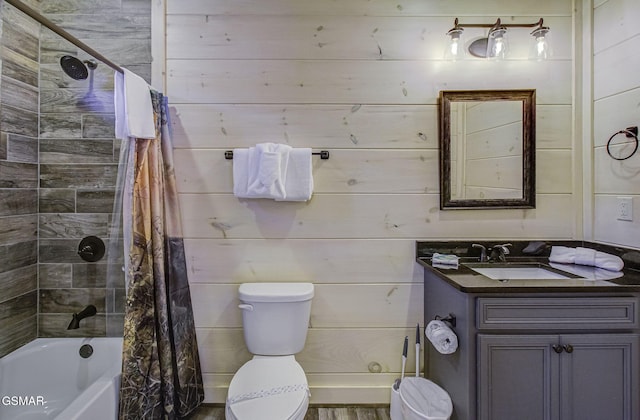 full bathroom featuring shower / bath combo, vanity, toilet, and wood walls