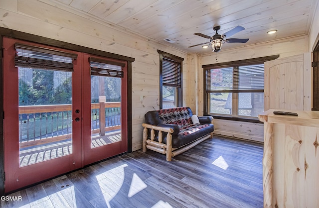 interior space featuring french doors, wooden walls, dark hardwood / wood-style floors, ceiling fan, and wood ceiling