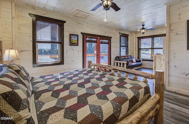 bedroom featuring french doors, access to outside, wooden ceiling, dark hardwood / wood-style floors, and wood walls