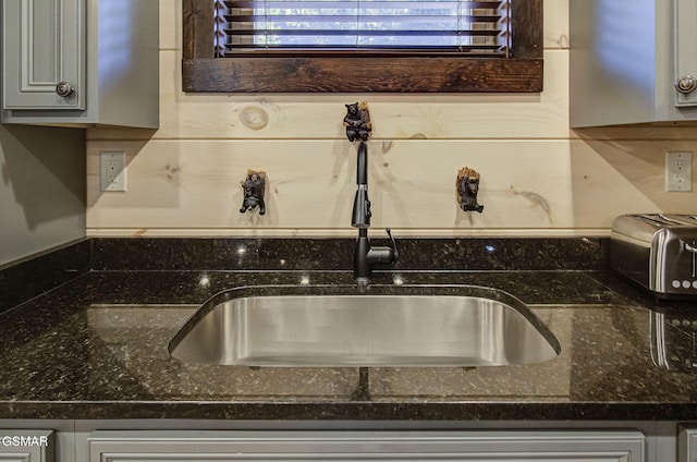 details featuring dark stone countertops, sink, and gray cabinets