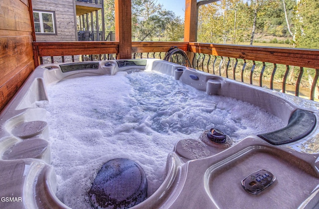 wooden terrace with a hot tub