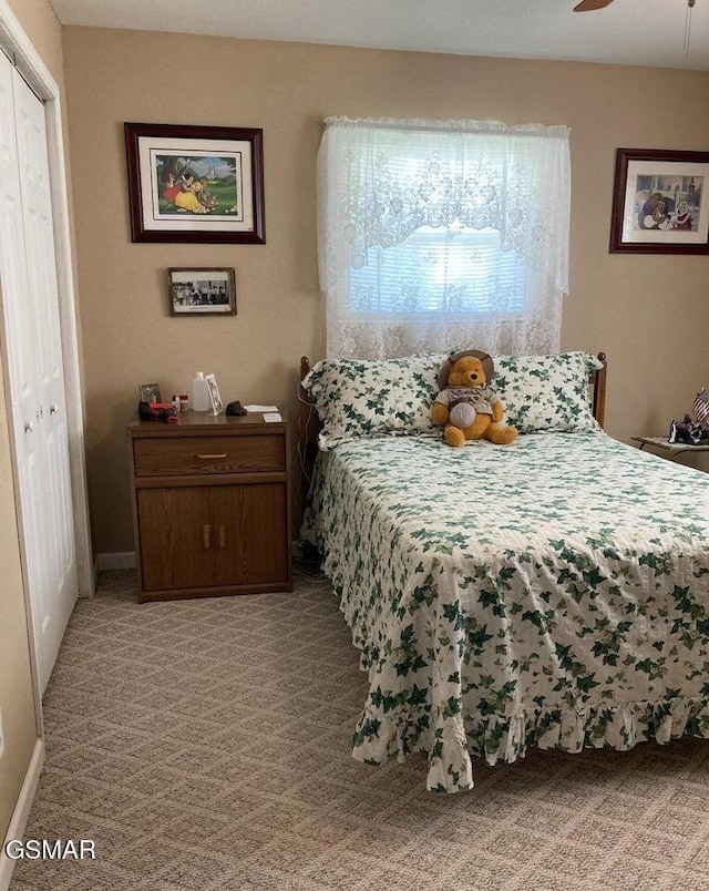 bedroom featuring baseboards, a ceiling fan, and light colored carpet