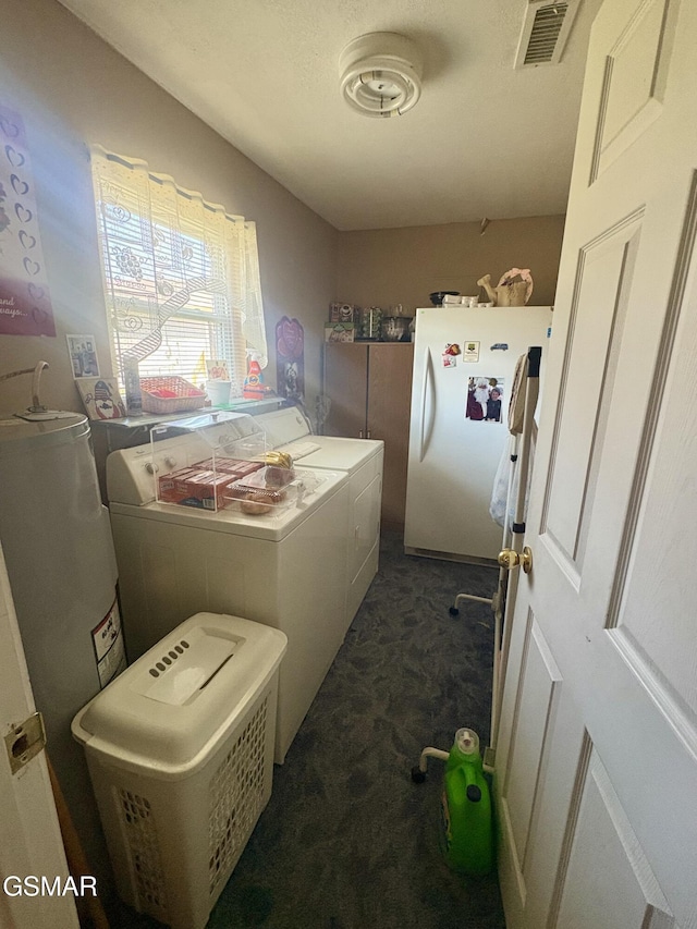 laundry area with laundry area, separate washer and dryer, dark carpet, and visible vents