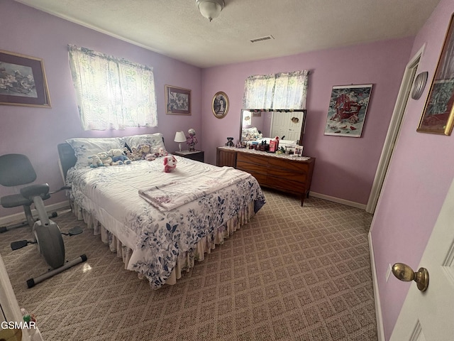 bedroom featuring baseboards, a textured ceiling, visible vents, and light colored carpet