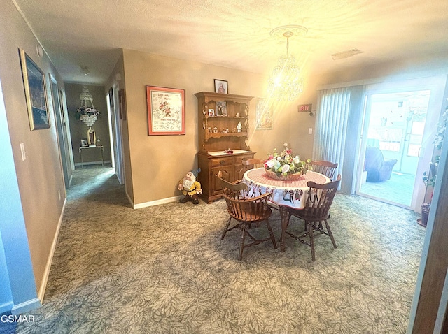 dining room with carpet floors, a chandelier, and baseboards