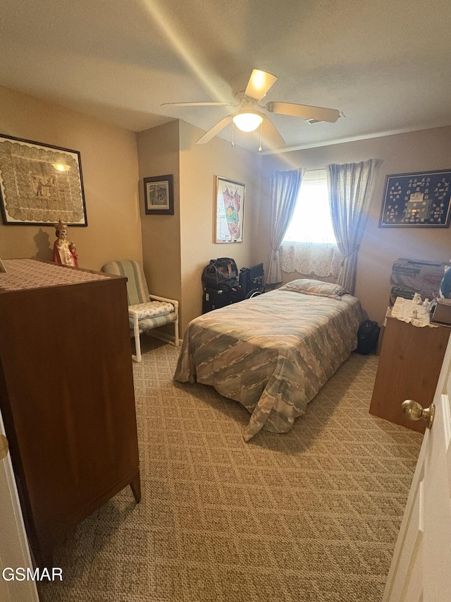 carpeted bedroom featuring a ceiling fan