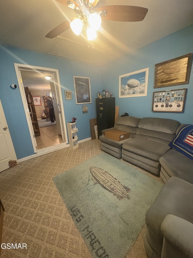 living room with carpet floors, attic access, ceiling fan, and baseboards