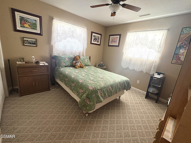 bedroom featuring multiple windows, light colored carpet, visible vents, and baseboards