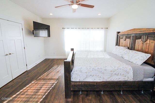 bedroom with ceiling fan and dark wood-type flooring