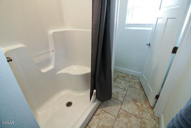 bathroom featuring a shower with curtain and tile patterned flooring