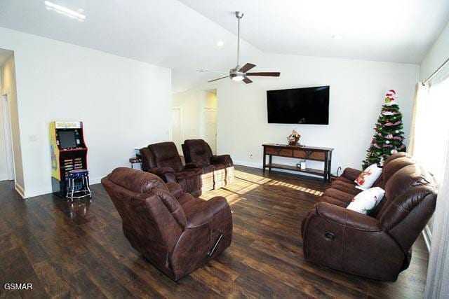 living room featuring dark hardwood / wood-style flooring, vaulted ceiling, and ceiling fan