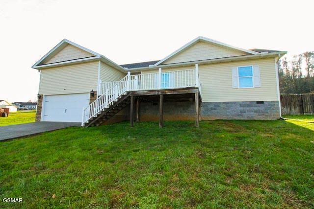 rear view of house with a yard