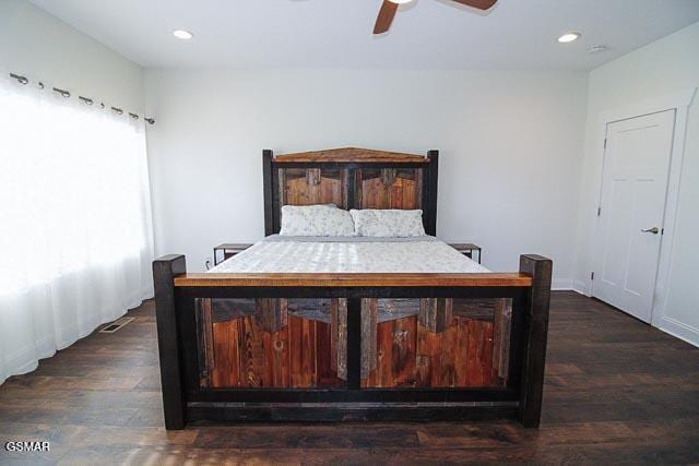 bedroom with ceiling fan and dark hardwood / wood-style flooring