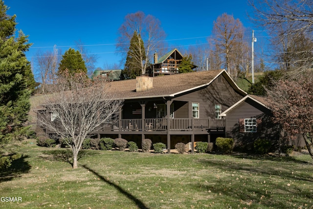 rear view of house featuring a lawn