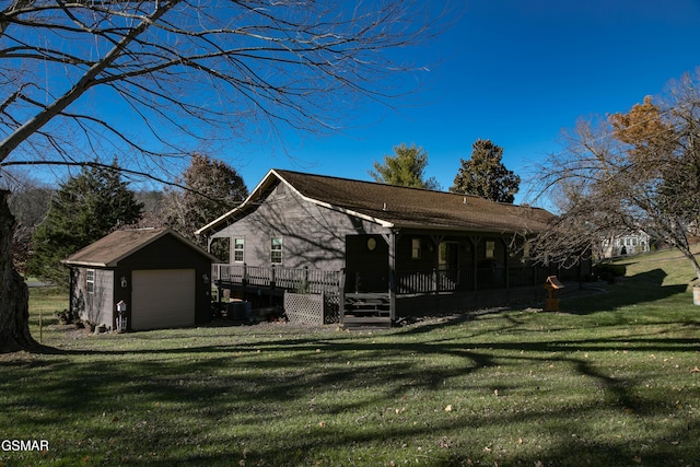 view of front of home with a deck, an outbuilding, a front yard, and a garage