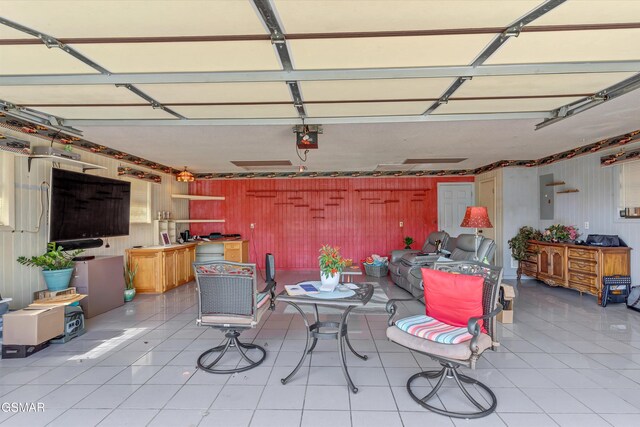 garage with a garage door opener and electric panel