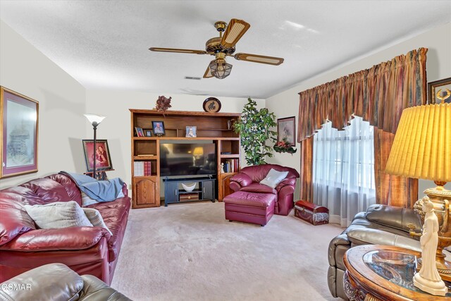 carpeted living room with ceiling fan