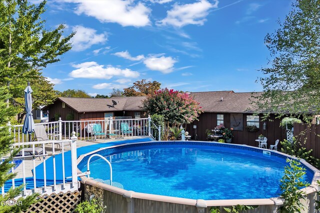 view of pool with a wooden deck