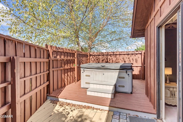 wooden terrace with a hot tub