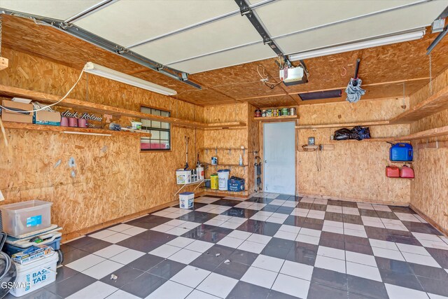 garage featuring wood walls and a garage door opener