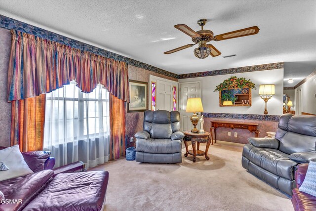 living room featuring a textured ceiling, carpet floors, and ceiling fan