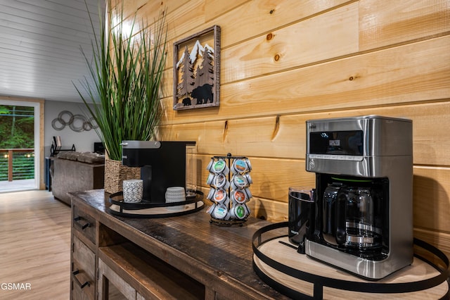 interior details featuring dark countertops, wooden walls, and wood finished floors