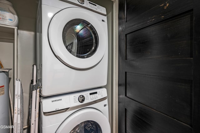 clothes washing area featuring stacked washer / drying machine and laundry area