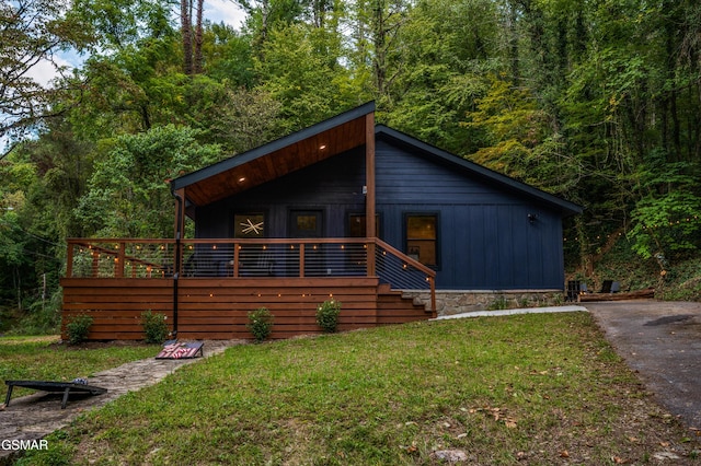 view of front of house featuring a front lawn and board and batten siding