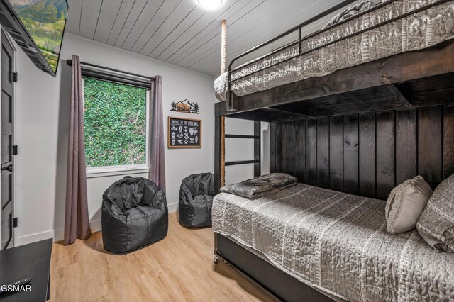 3033 N Clear Fork Rd, Sevierville, TN 37862 - bedroom with wooden walls, baseboards, and wood finished floors