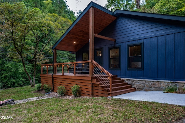 view of front of home with stone siding, board and batten siding, and a front yard