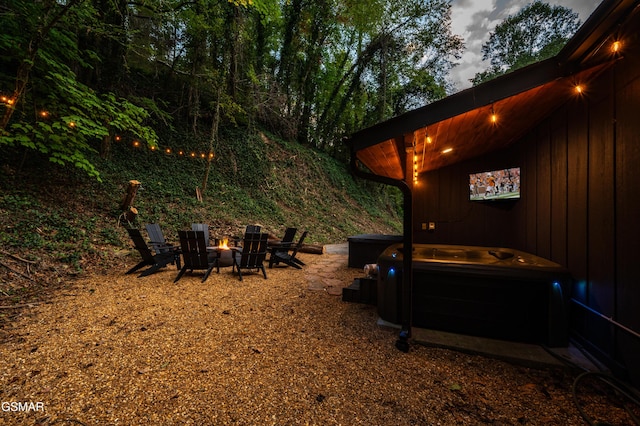 view of yard featuring an outdoor fire pit and a hot tub