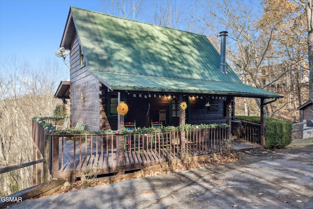 view of front of home featuring covered porch and metal roof