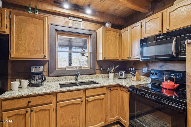 kitchen featuring wooden ceiling, beamed ceiling, light stone countertops, black appliances, and a sink