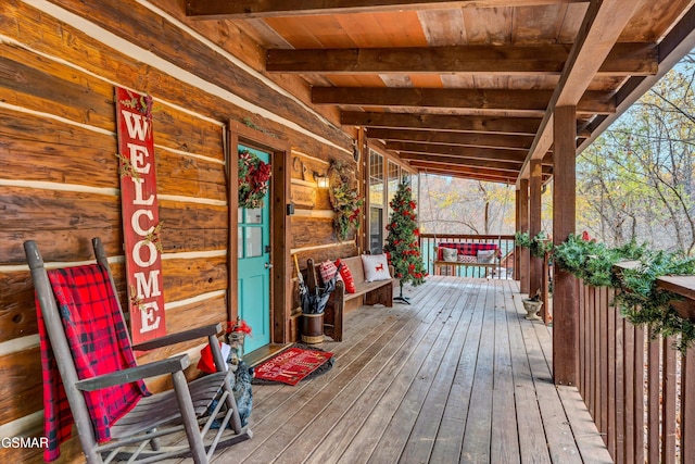 wooden terrace featuring covered porch