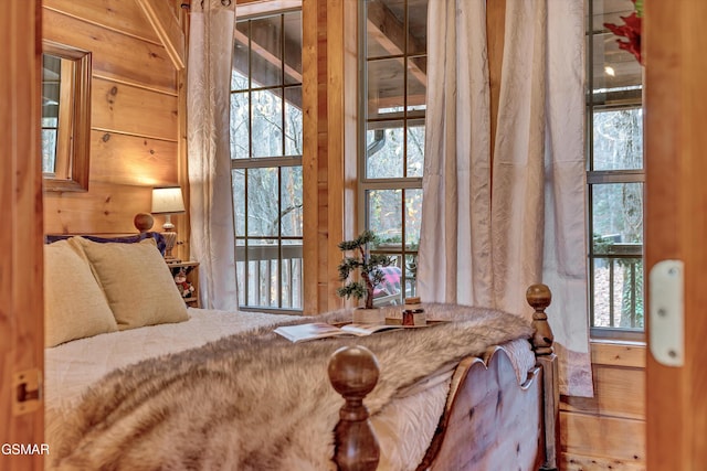 bedroom featuring wooden walls