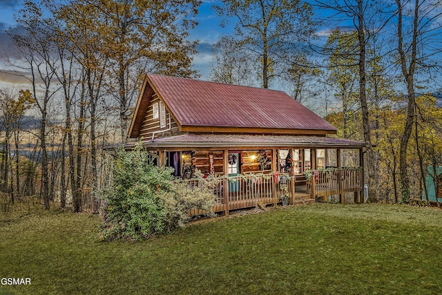 back of house with a lawn and a porch