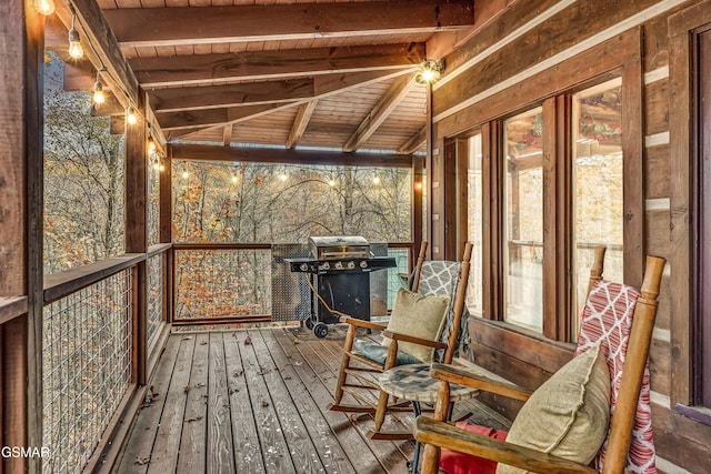 unfurnished sunroom with vaulted ceiling with beams and wood ceiling