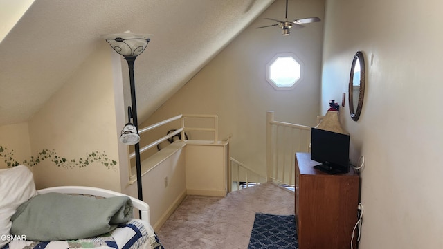 bedroom featuring a textured ceiling and vaulted ceiling