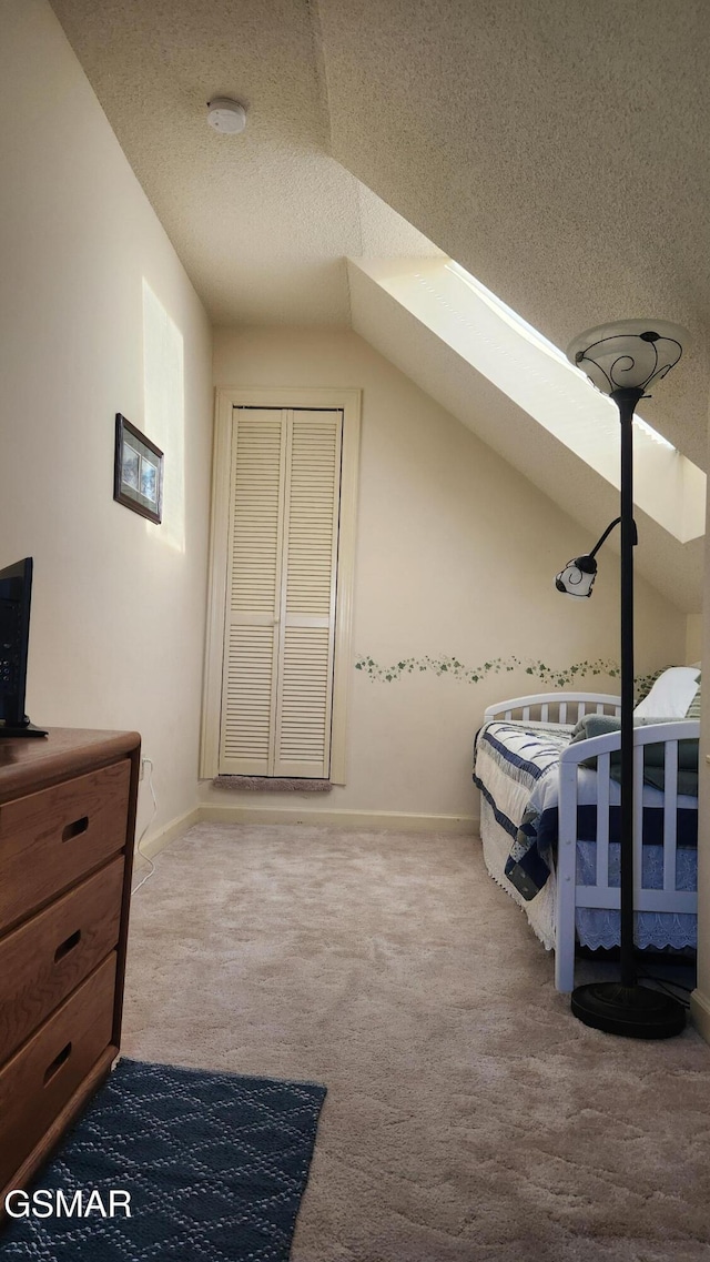 carpeted bedroom with vaulted ceiling and a textured ceiling