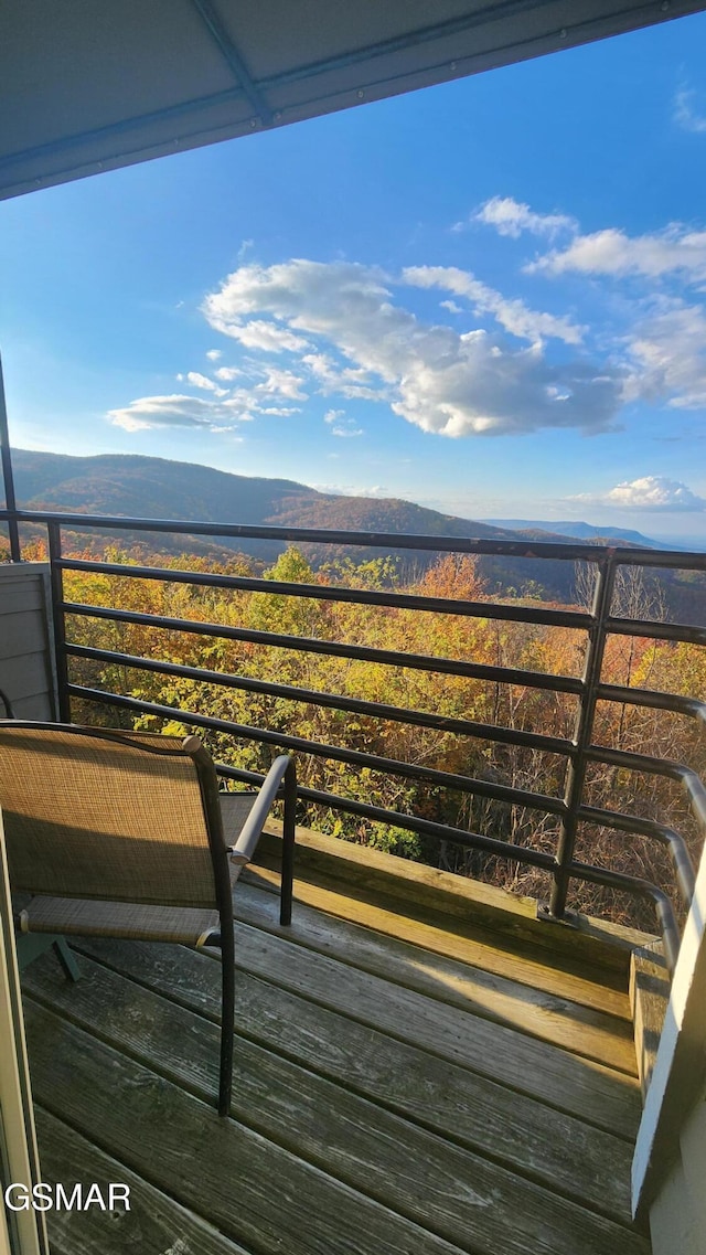 wooden deck with a mountain view