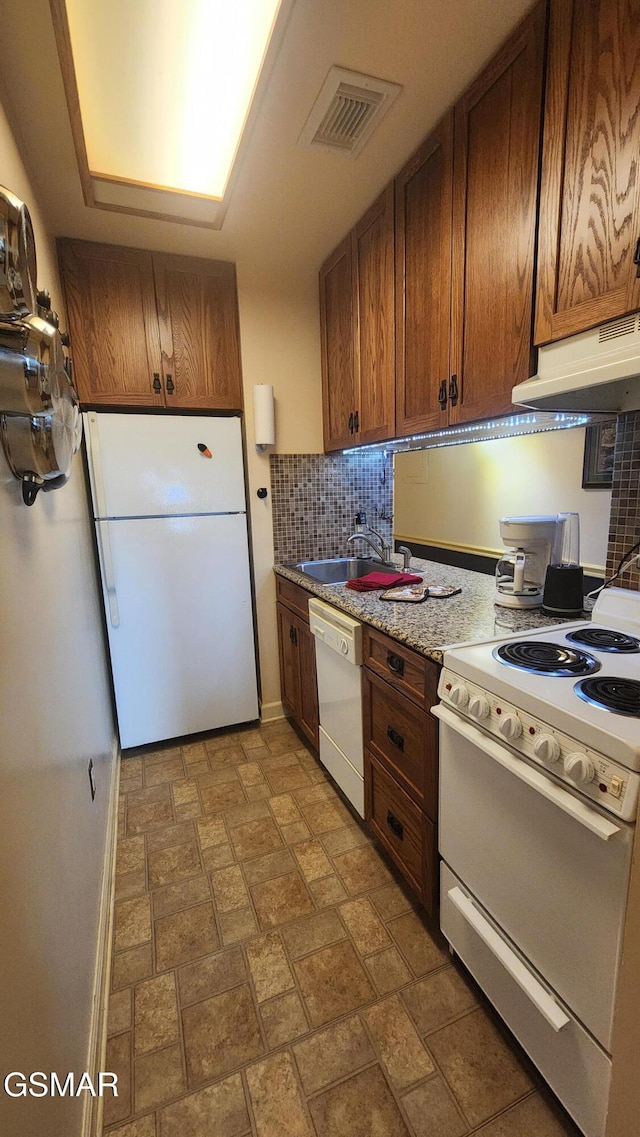 kitchen with ventilation hood, white appliances, backsplash, and sink