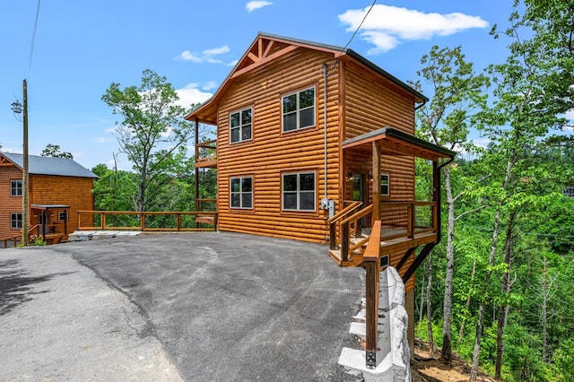 exterior space featuring faux log siding