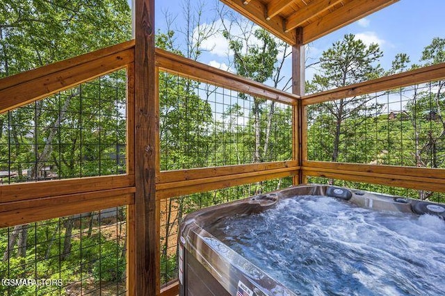 exterior space with beam ceiling and a jacuzzi