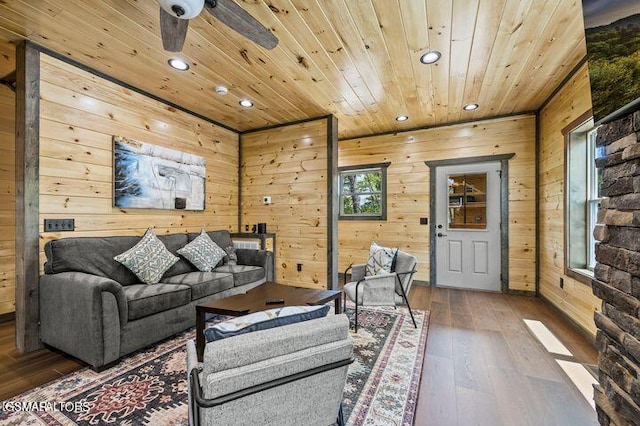 living room with wooden walls, recessed lighting, wood finished floors, a ceiling fan, and wood ceiling