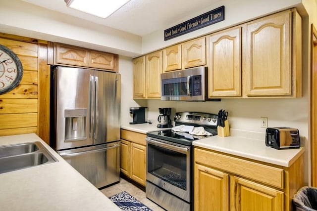1656 Racoon Den Way, Sevierville, TN 37862 - kitchen featuring appliances with stainless steel finishes, light countertops, light tile patterned flooring, and light brown cabinets