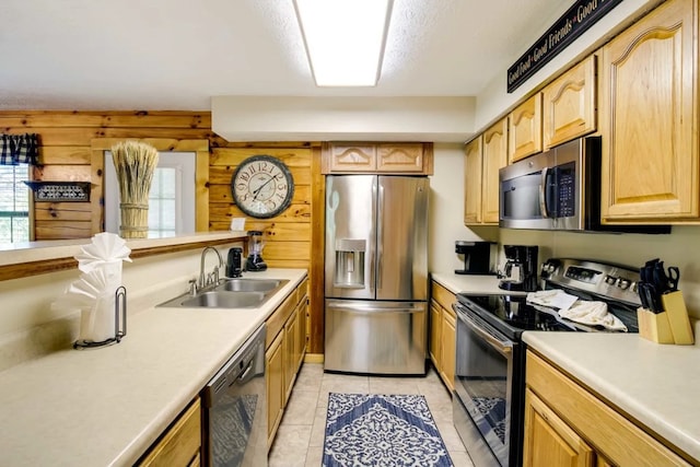 1656 Racoon Den Way, Sevierville, TN 37862 - kitchen with appliances with stainless steel finishes, light countertops, light brown cabinets, and light tile patterned floors