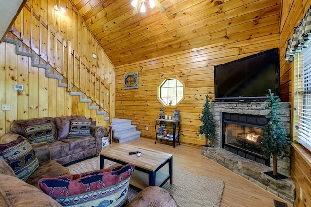1656 Racoon Den Way, Sevierville, TN 37862 - living area with wood finished floors, stairs, a fireplace, wood walls, and lofted ceiling