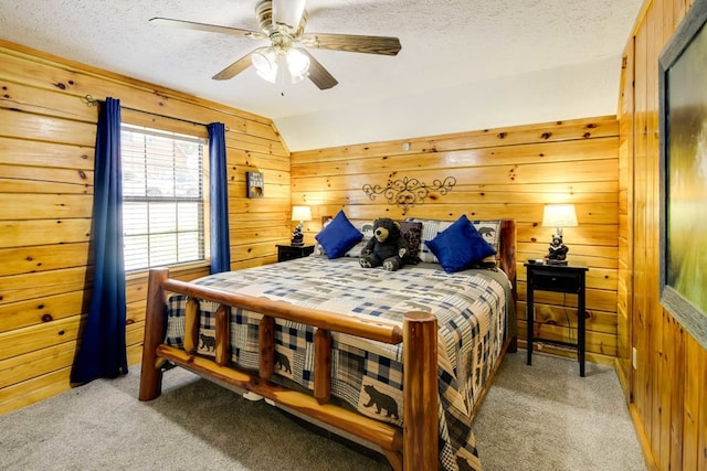 1656 Racoon Den Way, Sevierville, TN 37862 - bedroom with light colored carpet, wooden walls, a textured ceiling, vaulted ceiling, and a ceiling fan