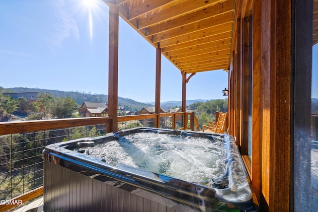 wooden terrace with a mountain view and a hot tub